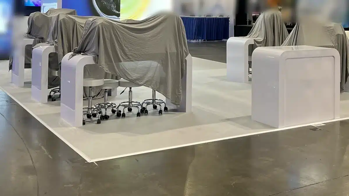 Stoisko targowe gotowe przed otwarciem, sprzęt przykryty pokrowcami